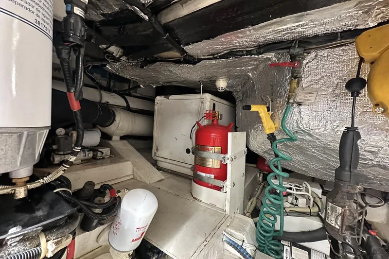 Slide: The Image of Engine room of 2007 Mochi Craft 44 Dolphin yacht with fire extinguisher and equipment. - 30