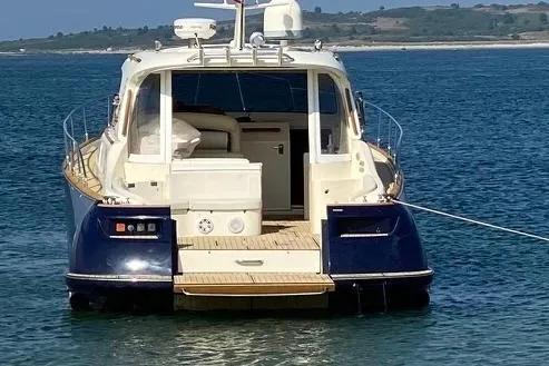 Slide: The Image of 2007 Mochi Craft 44 Dolphin yacht on calm water, rear view. - 4