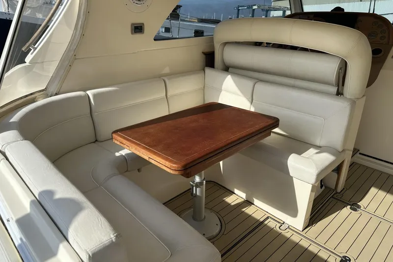 Slide: The Image of Luxurious seating area on 2007 Mochi Craft 44 Dolphin yacht with wooden table. - 9