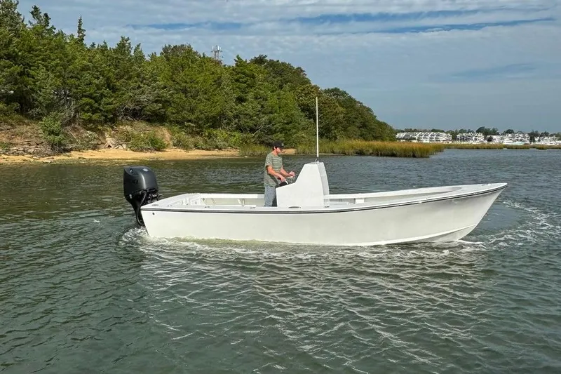 Slide: The Image of 2025 Privateer 20 Roamer boat cruising on a scenic lake with lush greenery. - 10