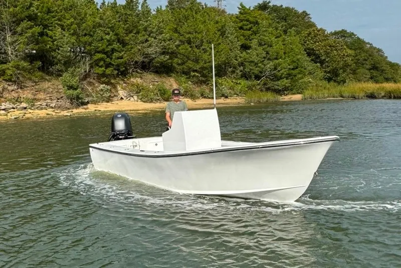 Slide: The Image of 2025 Privateer 20 Roamer boat cruising on a calm river near a forested shoreline. - 12