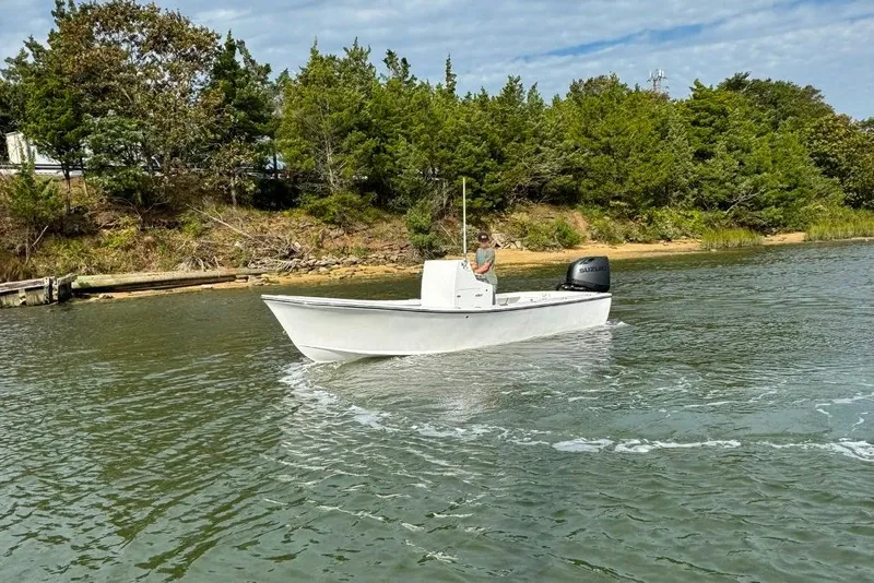 Slide: The Image of 2025 Privateer 20 Roamer boat cruising near a wooded shoreline. - 14
