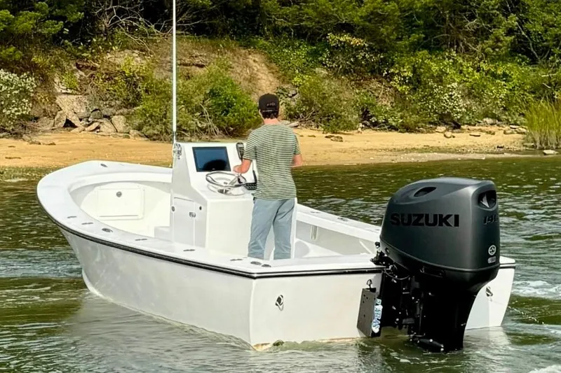 Slide: The Image of 2025 Privateer 20 Roamer boat with Suzuki outboard motor on a calm river. - 16