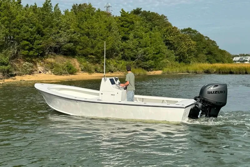 Slide: The Image of 2025 Privateer 20 Roamer boat cruising near a lush shoreline. - 21