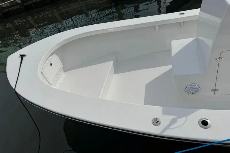 Slide: The Image of Privateer 20 Roamer 2025 boat interior, featuring sleek white seating and storage compartments. - 26