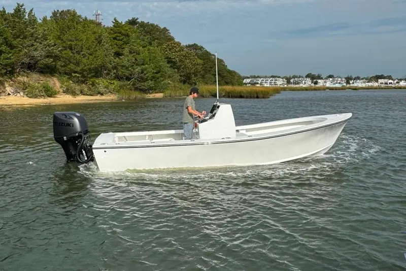 Slide: The Image of 2025 Privateer 20 Roamer boat cruising on a calm lake with lush greenery. - 9