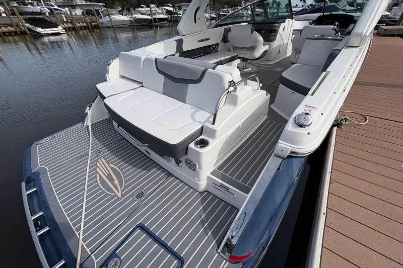 Slide: The Image of 2018 CHAPPARAL 287 SSX boat docked at marina, featuring sleek design and spacious seating. - 12