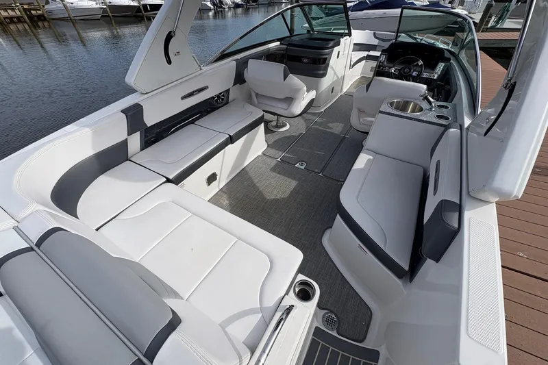 Slide: The Image of 2018 CHAPPARAL 287 SSX boat with spacious seating at a marina dock. - 13