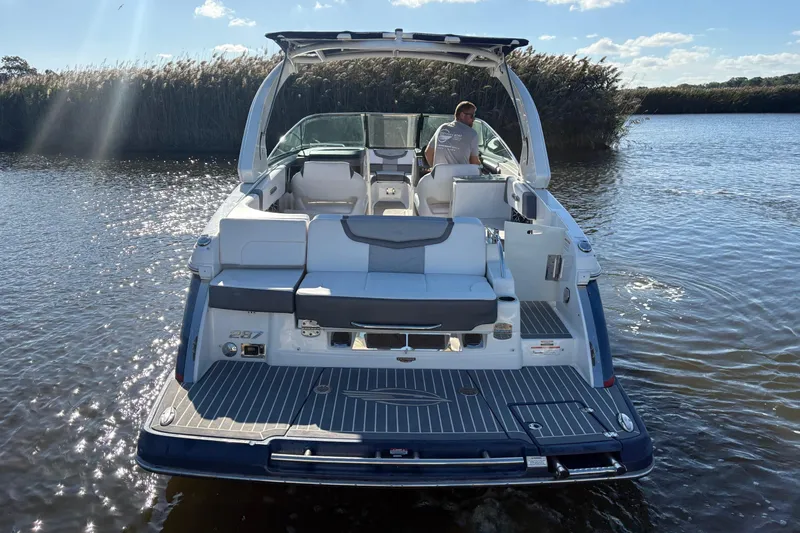 Slide: The Image of 2018 Chaparral 287 SSX boat on calm water under a clear sky. - 5