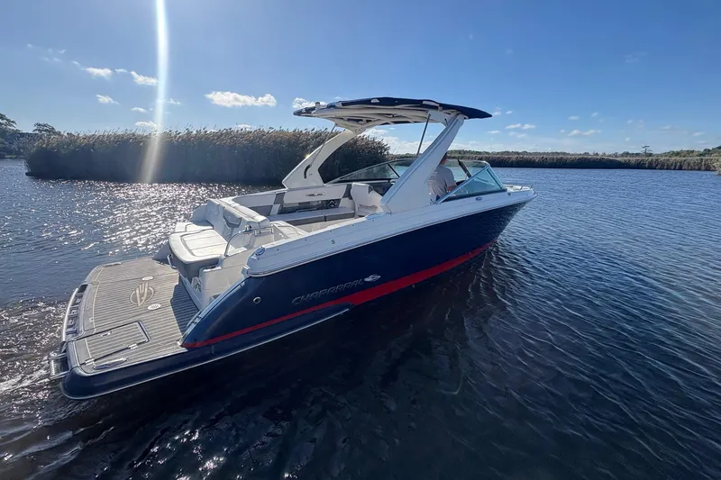 Slide: The Image of 2018 Chaparral 287 SSX boat on calm water under a sunny sky. - 6