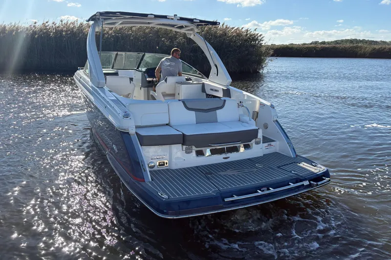Slide: The Image of 2018 Chaparral 287 SSX boat on calm water under clear blue sky. - 8