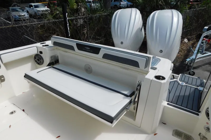 Slide: The Image of 2026 Cobia 285 Center Console boat with open storage compartments and visible engines. - 11