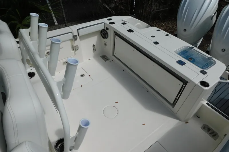 Slide: The Image of 2026 Cobia 285 Center Console boat with foldable seating and dual outboard engines. - 12