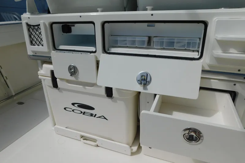 Slide: The Image of 2026 Cobia 285 Center Console boat interior with storage compartments and cooler. - 15