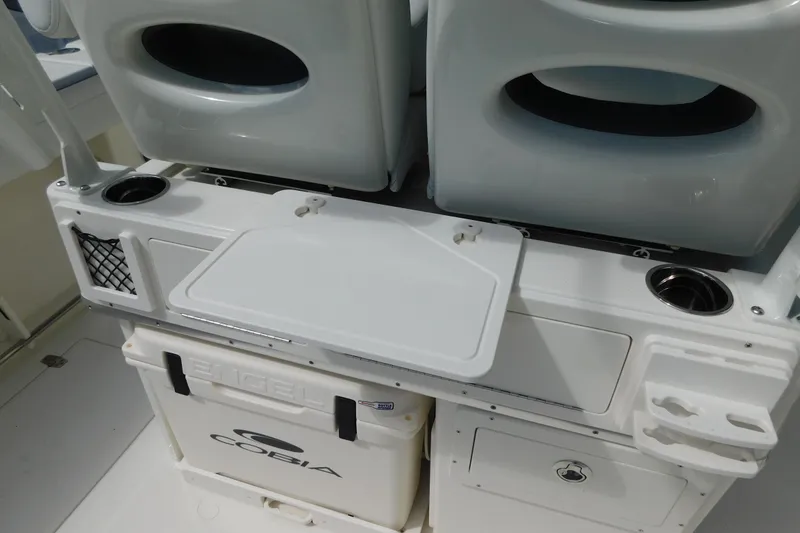 Slide: The Image of 2026 Cobia 285 Center Console storage compartments with drawers and cooler. - 16