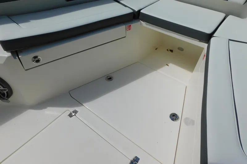 Slide: The Image of 2026 Cobia 285 Center Console boat interior with cushioned seating and speakers. - 22
