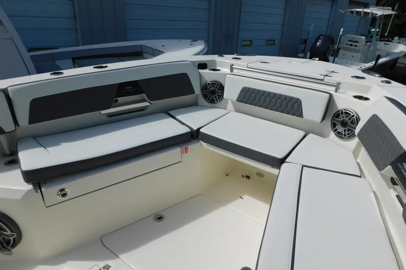 Slide: The Image of 2026 Cobia 285 Center Console boat interior with storage compartments and cushioned seating. - 23