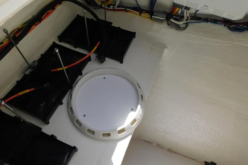 Slide: The Image of Anchor compartment of 2026 Cobia 285 Center Console boat, featuring chain and winch. - 27