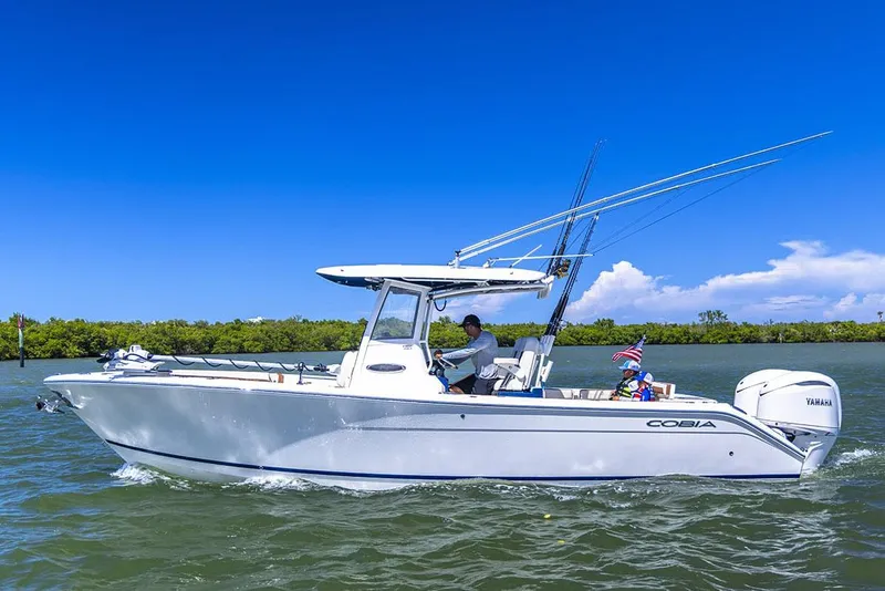 Slide: The Image of Manufacturer Provided Image: 2025 Cobia 285 Center Console boat cruising on open water. - 3