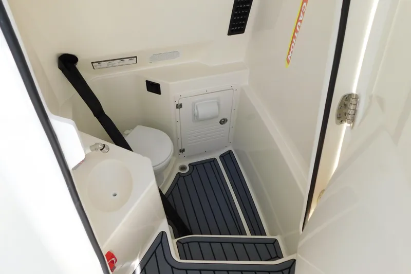 Slide: The Image of Open storage compartment on 2026 Cobia 285 Center Console boat with branded bag inside. - 31