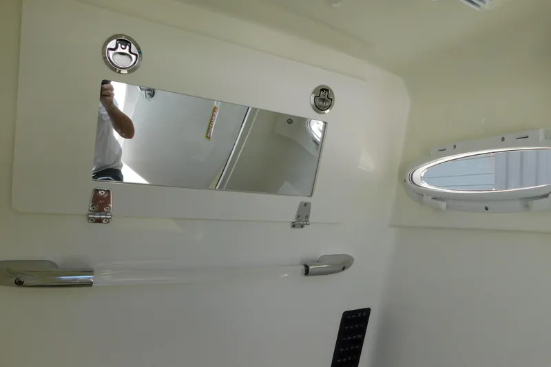 Slide: The Image of 2026 Cobia 285 Center Console boat bathroom with sink and toilet. - 33