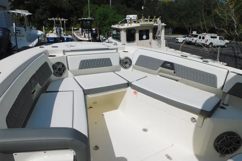 Slide: The Image of 2026 Cobia 285 Center Console boat interior with cushioned seating and stylish design. - 36