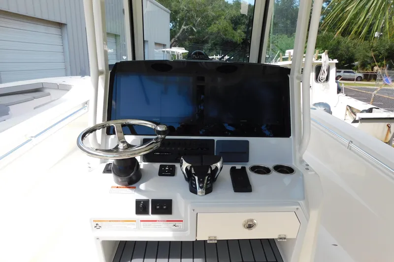 Slide: The Image of Manufacturer Provided Image: 2025 Cobia 285 Center Console boat cruising on a sunny day. - 4