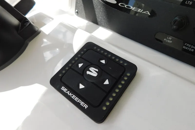 Slide: The Image of Close-up of a 2026 Cobia 285 Center Console boat's antenna and cleat. - 40