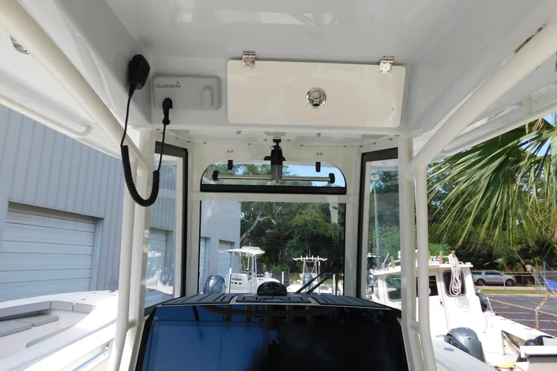 Slide: The Image of 2026 Cobia 285 Center Console boat dashboard with steering wheel and controls. - 5