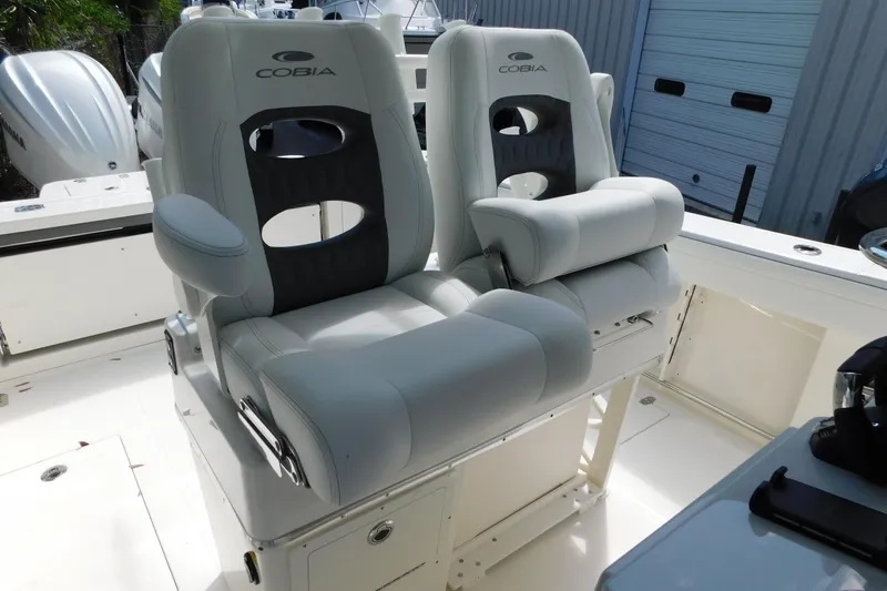 Slide: The Image of 2026 Cobia 285 Center Console boat with dual cushioned seats. - 7