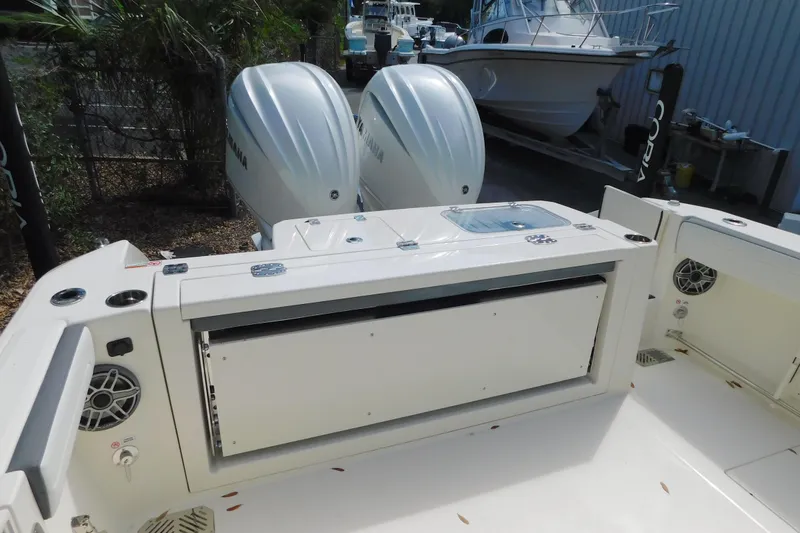Slide: The Image of 2026 Cobia 285 Center Console boat helm with steering wheel and controls. - 9