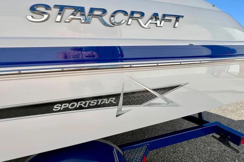Slide: The Image of 2014 Starcraft 2000 OB Limited boat with Sportstar branding and blue accents. - 4