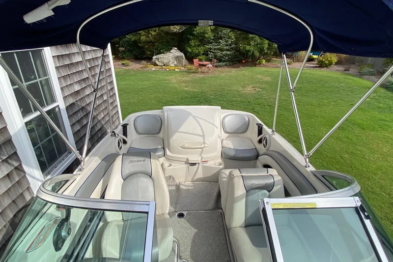 Slide: The Image of 2008 Sea Ray 175 Sport boat interior with canopy, parked on grass. - 12