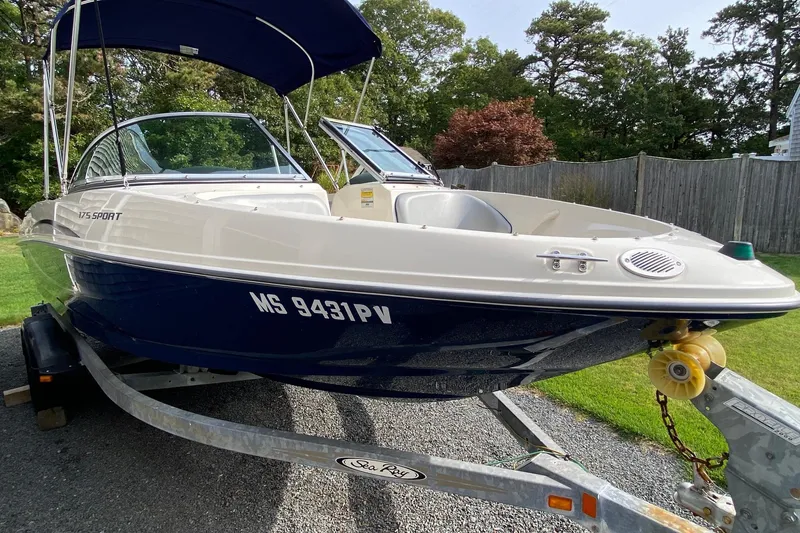 Slide: The Image of 2008 Sea Ray 175 Sport boat on trailer, parked in a grassy yard. - 3