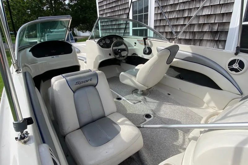 Slide: The Image of 2008 Sea Ray 175 Sport boat interior with white and gray seating, steering wheel, and dashboard. - 7