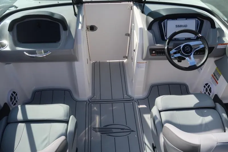 Slide: The Image of 2026 Chaparral 21 SSi boat interior with steering wheel and seating. - 14