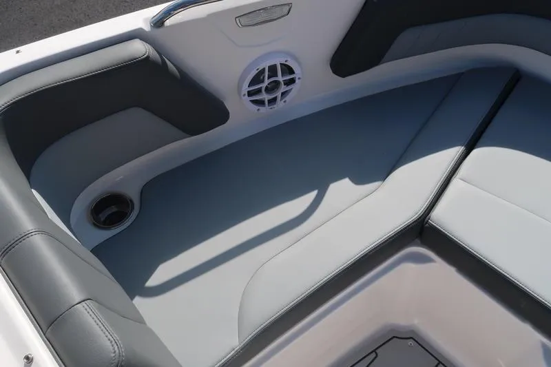 Slide: The Image of 2026 Chaparral 21 SSi boat storage compartment with black non-slip mat. - 21