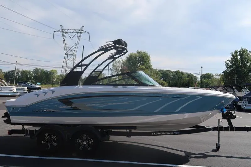 Slide: The Image of 2026 Chaparral 21 SSi boat on trailer, sleek design, blue and white exterior. - 6