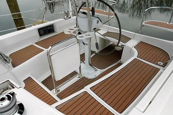 Slide: The Image of 2006 Hunter 38 sailboat cockpit with teak flooring and steering wheel. - 12