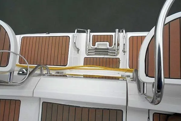 Slide: The Image of Hunter 38 sailboat deck, 2006 model, featuring teak flooring and stainless steel railings. - 13