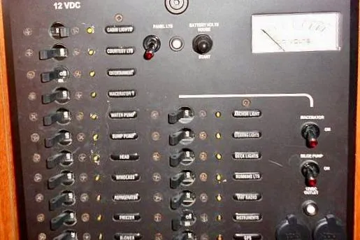 Slide: The Image of 2006 Hunter 38 yacht interior with wooden navigation station and cozy seating area. - 20