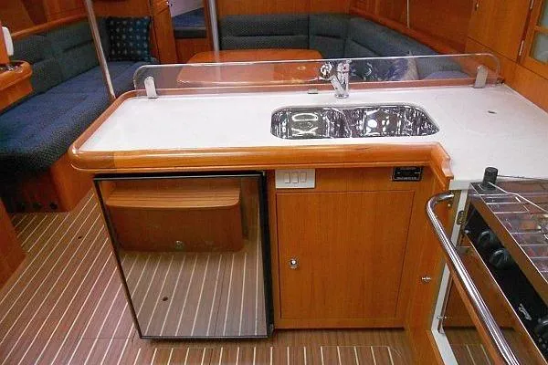 Slide: The Image of Cozy dining area in 2006 Hunter 38 yacht with wooden table and cushioned seating. - 27