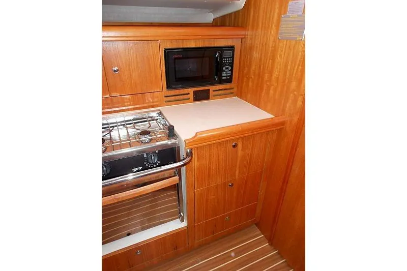 Slide: The Image of Interior of 2006 Hunter 38 sailboat with wooden finish and navigation equipment. - 32