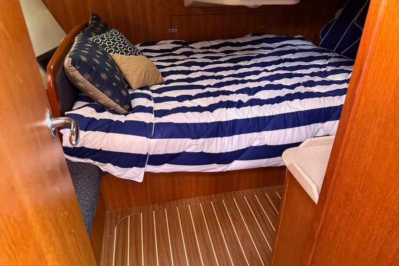 Slide: The Image of Interior of 2006 Hunter 38 sailboat with wood finish and compact layout. - 36