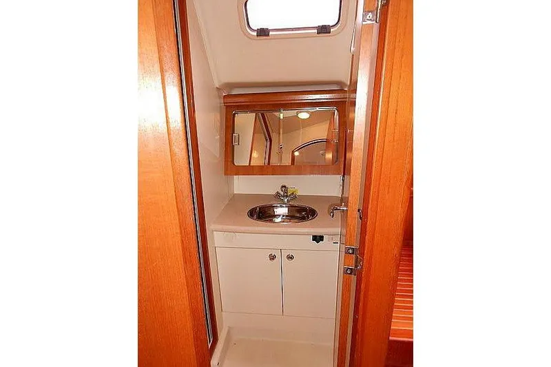 Slide: The Image of Wooden interior steps with storage on a 2006 Hunter 38 sailboat. - 37