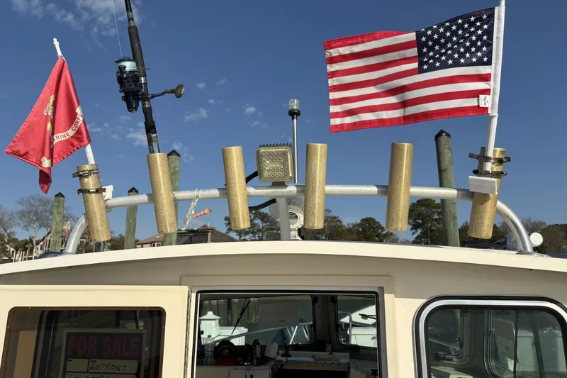 Slide: The Image of 2006 Parker 2520 XL Sport Cabin boat with American and Marine Corps flags displayed. - 10
