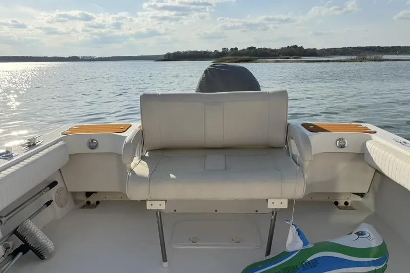 Slide: The Image of 2006 Parker 2520 XL Sport Cabin boat interior with seating, on a sunny day by the water. - 3
