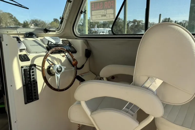Slide: The Image of 2006 Parker 2520 XL Sport Cabin helm with steering wheel and navigation equipment. - 5