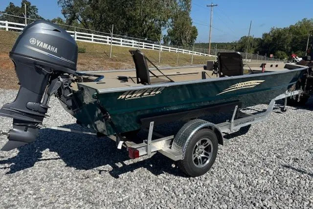 Slide: The Image of 2025 Alweld 1856 PF boat with Yamaha motor on trailer, parked on gravel. - 14