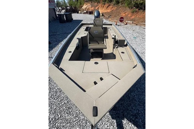 Slide: The Image of 2025 Alweld 1856 PF boat on gravel, featuring spacious deck and seating. - 16